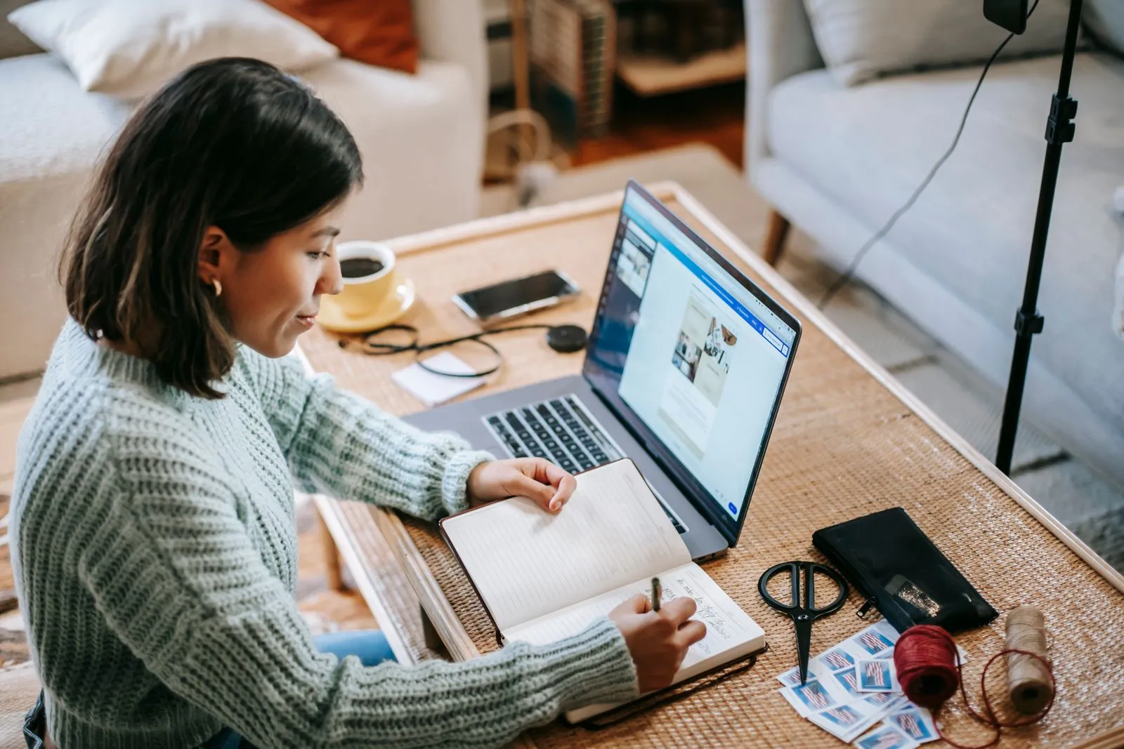 Persona tomando apuntes frente a su computador mientras avanza en un curso online